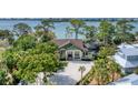 Luxury waterfront home with private drive and lush landscaping at 603 Harbor Shore Dr, Nokomis, FL 34275