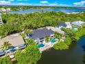 Aerial view showcasing home's waterfront location and pool at 6530 Peacock Rd, Sarasota, FL 34242