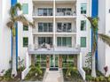 Modern building with multiple balconies and palm trees at 711 S Palm Ave # 303, Sarasota, FL 34236