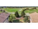 Landscaped backyard with lush greenery and golf course view at 7486 Divot Loop # 7486, Bradenton, FL 34202