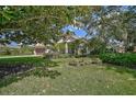 House with mature trees and well-manicured lawn at 7503 Eaton Ct, University Park, FL 34201