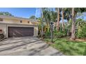 Exterior view of condo showing garage and landscaping at 7938 Pinegrove Ct # 12, Sarasota, FL 34238