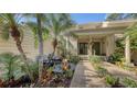 Inviting condo entry with a relaxing patio and tropical landscaping at 7938 Pinegrove Ct # 12, Sarasota, FL 34238