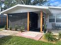 Front view of the house showcasing the screened porch and entrance at 980 Charlotte Ave, Sarasota, FL 34237