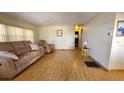 Spacious living room with light wood floors and reclining furniture at 10315 Cortez W Rd # 37F, Bradenton, FL 34210