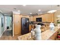 Bright kitchen with light wood cabinets, granite countertops, and stainless steel appliances at 1106 49Th Avenue W Dr, Bradenton, FL 34207