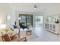 Bright living room featuring a comfortable sofa, stylish decor, and a seamless transition to the lanai at 12651 Garibaldi Ln, Venice, FL 34293