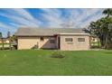 Back exterior showing additional structure and grassy yard at 13457 Muriel Ave, Port Charlotte, FL 33981