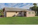 Back exterior showing additional structure and grassy yard at 13457 Muriel Ave, Port Charlotte, FL 33981