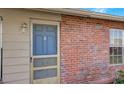 Front entry with blue door and brick facade at 13457 Muriel Ave, Port Charlotte, FL 33981