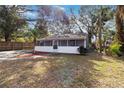 Quaint house with a screened porch and a partially fenced yard at 1376 18Th St, Sarasota, FL 34234