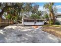 Front view of a charming house with a large yard and driveway at 1376 18Th St, Sarasota, FL 34234