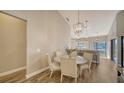 Dining area with glass-top table and four white chairs at 1620 Starling Dr # 204, Sarasota, FL 34231