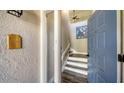 Front entry with gray door and staircase leading upstairs at 1620 Starling Dr # 204, Sarasota, FL 34231