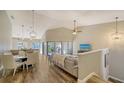 Spacious living room with vaulted ceiling, L-shaped sofa, and access to balcony at 1620 Starling Dr # 204, Sarasota, FL 34231