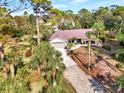 Ranch-style home on a large lot with tropical landscaping at 1819 Bridge St, Englewood, FL 34223