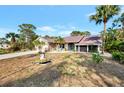One-story home with a large yard and palm trees at 1819 Bridge St, Englewood, FL 34223