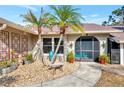Inviting front entrance with unique landscaping and teal door at 1819 Bridge St, Englewood, FL 34223