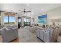 Spacious living room with water views, featuring comfortable seating and large artwork at 1918 Harbourside Dr # 902, Longboat Key, FL 34228