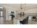 Island kitchen with white cabinets, granite counters, and stainless steel appliances at 19344 Cruise Dr, Venice, FL 34292
