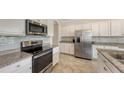 Modern kitchen with stainless steel appliances and granite countertops at 19344 Cruise Dr, Venice, FL 34292