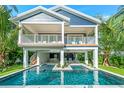 Two-story home with private pool and tropical landscaping at 2208 Avenue A, Bradenton Beach, FL 34217