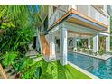 Elevated home with wooden staircase leading to the pool at 2208 Avenue A, Bradenton Beach, FL 34217