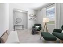 Living room with green armchairs and a neutral color scheme at 3490 Ikola Ave, North Port, FL 34288