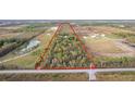 Triangular lot with mature trees and surrounding landscape at 39200 Cook Brown Rd, Punta Gorda, FL 33982
