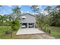 Elevated home with carport and stairs leading to the entrance at 39200 Cook Brown Rd, Punta Gorda, FL 33982