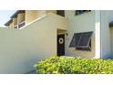 Condo building entrance with lush landscaping at 4532 Longwater Chase # 37, Sarasota, FL 34235