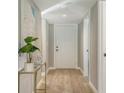Bright hallway with light flooring and decor at 4532 Longwater Chase # 37, Sarasota, FL 34235