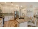 Bright kitchen with stainless steel appliances, granite countertops, and a large island with seating at 5097 Faberge Pl, Sarasota, FL 34233