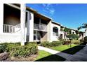 Condo building showcasing walkway, landscaping, and building details at 5281 Mahogany Run Ave # 822, Sarasota, FL 34241