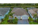 Luxury home with a two-car garage and nicely landscaped yard at 5601 Long Shore Loop, Sarasota, FL 34238