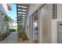 Inviting entryway with brick path and exterior staircase at 6047 E Peppertree Way # 224, Sarasota, FL 34242