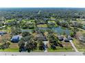Aerial view of home on a lake with surrounding houses at 6300 26Th E Ave, Bradenton, FL 34208