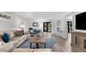 Bright living room with comfy sofas, a coffee table, and access to a balcony at 6326 Midnight Pass Rd # 101, Sarasota, FL 34242