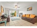 Relaxing living room with leather sofas, tile floors and access to patio at 6703 Midnight Pass Rd # 108B, Sarasota, FL 34242
