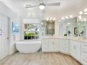 Spa-like bathroom with soaking tub and dual sinks at 7207 Saint Johns Way, University Park, FL 34201