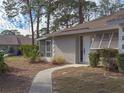 Tan house exterior with walkway, landscaping, and neighboring house visible at 727 N Jefferson Ave # 727, Sarasota, FL 34237