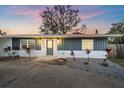 House exterior features gray siding, white accents, and landscaping at 8204 Constance Dr, Sarasota, FL 34243