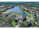 Aerial view of a house showcasing its location on a lake within a community at 9420 Old Hyde Park Pl, Lakewood Ranch, FL 34202