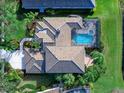 Bird's eye view of a home with pool and lush landscaping at 9420 Old Hyde Park Pl, Lakewood Ranch, FL 34202