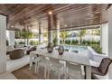Outdoor dining area with pool and wooden ceiling at 105 6Th S St, Bradenton Beach, FL 34217