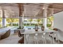 Outdoor dining area with pool and wooden ceiling at 105 6Th S St, Bradenton Beach, FL 34217