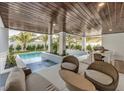 Covered patio with seating area and a view of the pool at 105 6Th S St, Bradenton Beach, FL 34217