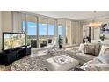 Open-concept living room featuring floor-to-ceiling windows with scenic views at 130 Riviera Dunes Way # 1104, Palmetto, FL 34221