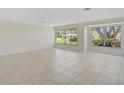 Bright and airy living room with tile flooring and large windows at 1312 Stafford Ln # 1427, Sarasota, FL 34232