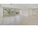 Living room with tile floors and large windows offering ample natural light at 1312 Stafford Ln # 1427, Sarasota, FL 34232